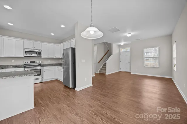 a view of kitchen with sink microwave refrigerator and stove