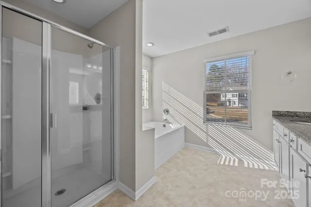 a bathroom with a bathtub and shower