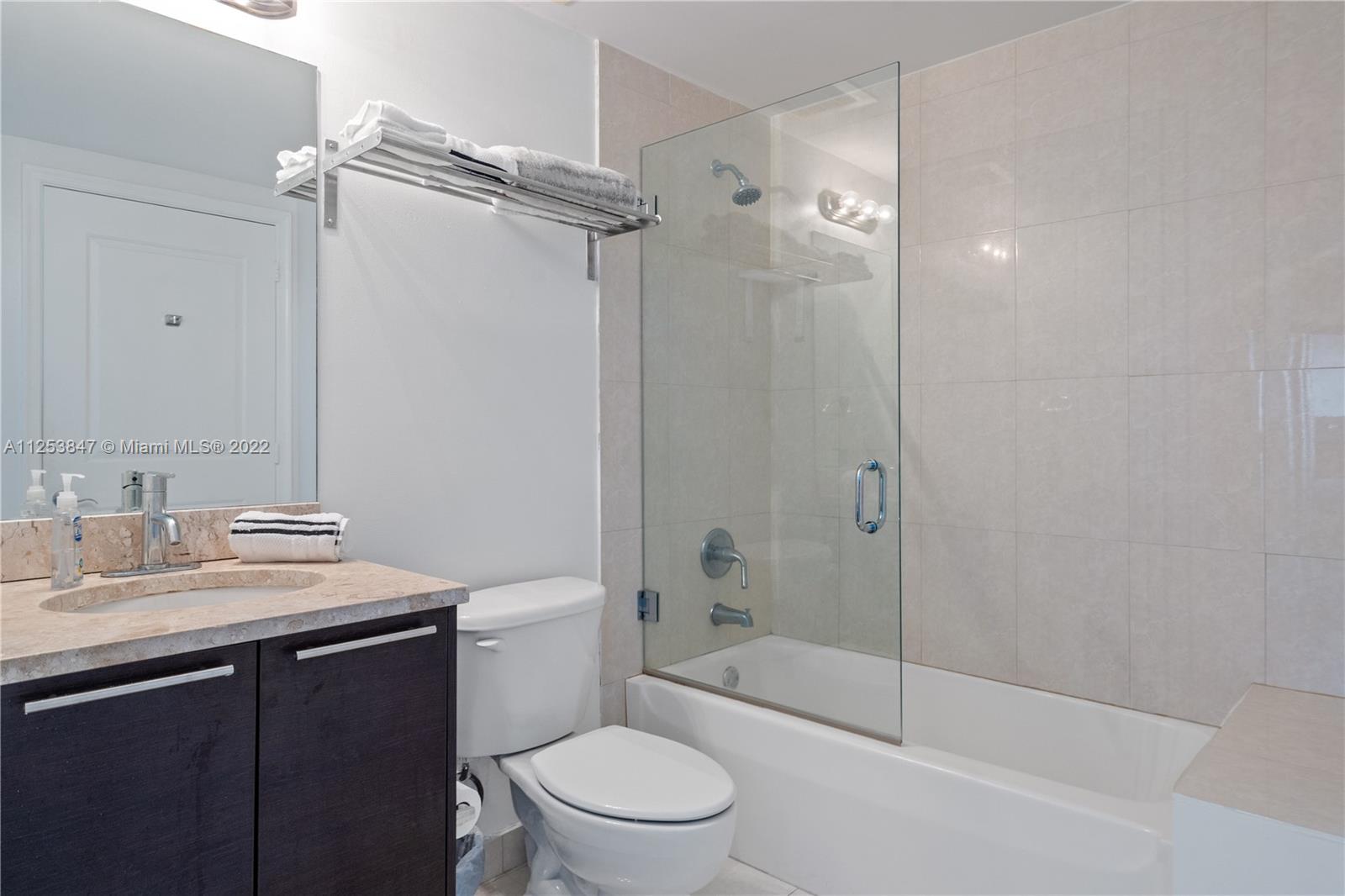 480 Northeast 30th Street, Unit 2003 Miami, FL 33137 - Photo 12 of 17 a bathroom with a sink a toilet and shower