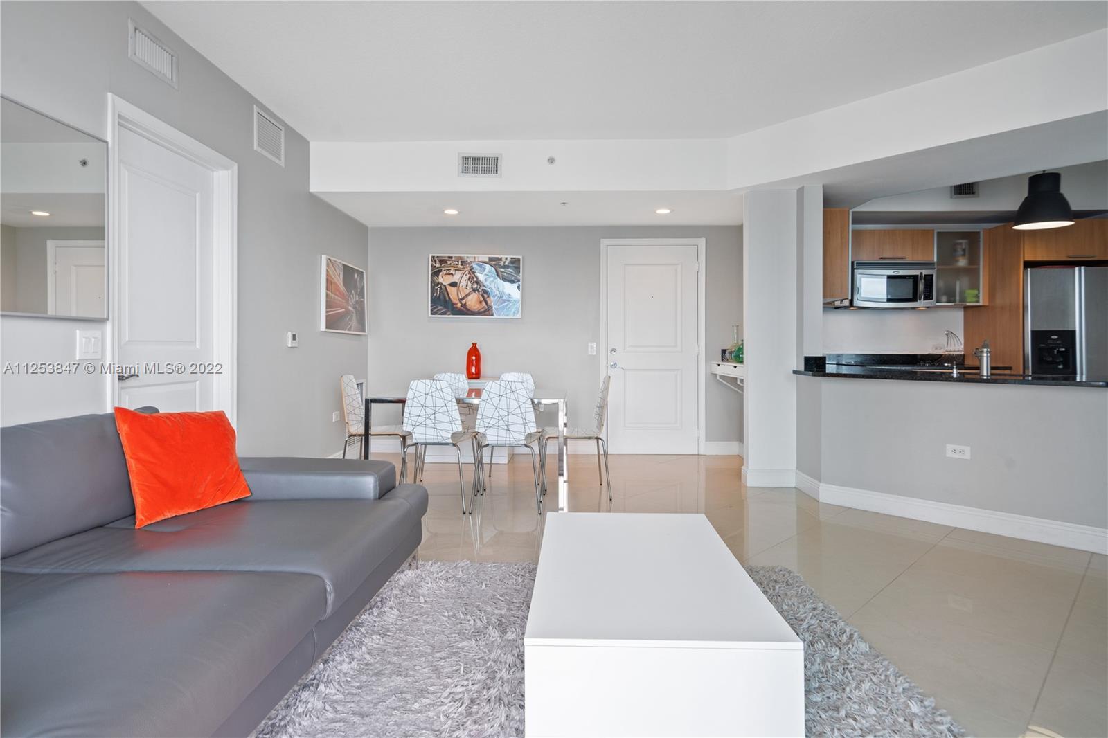 480 Northeast 30th Street, Unit 2003 Miami, FL 33137 - Photo 7 of 17 a living room with furniture and wooden floor