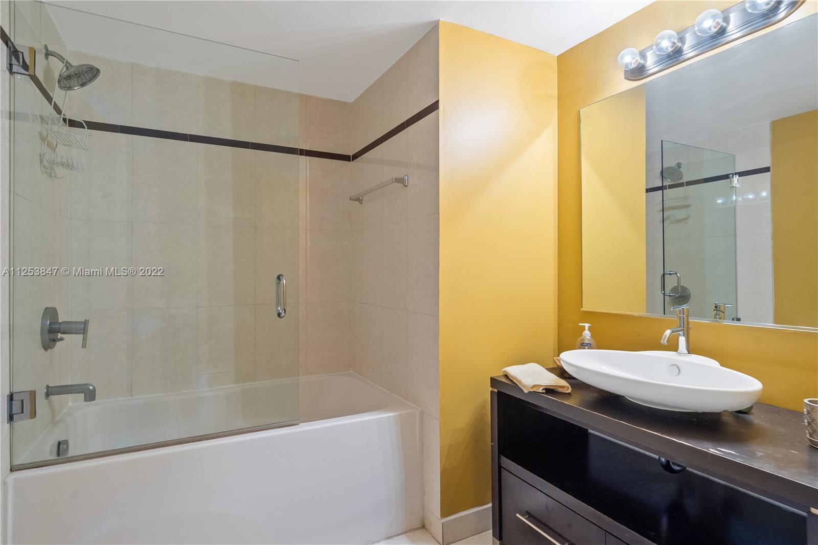 480 Northeast 30th Street, Unit 2003 Miami, FL 33137 - Photo 10 of 17 a bathroom with a sink and a mirror