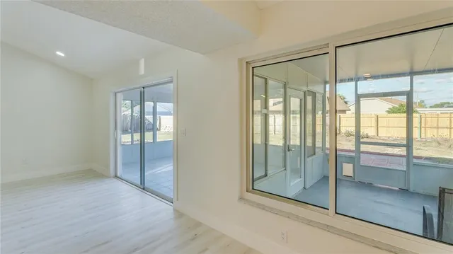 a view of a kitchen with a sink and refrigerator