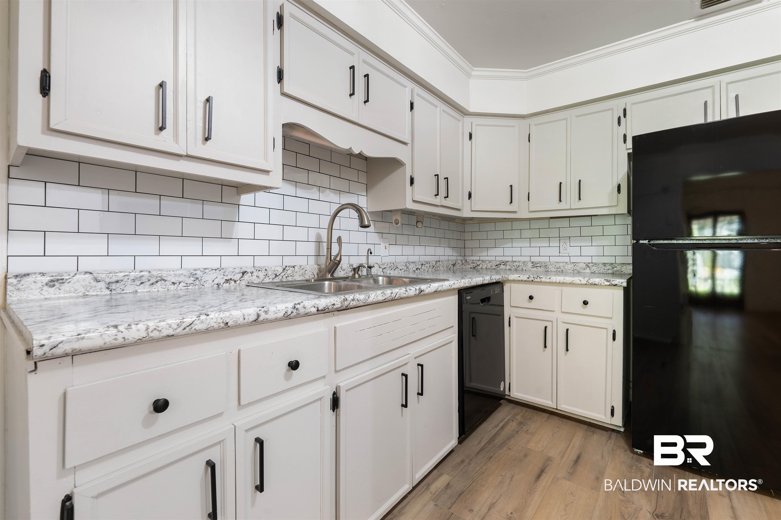 4667 Bit And Spur Road Mobile, AL 36608 - Photo 10 of 27 Kitchen with black appliances, tasteful backsplash, crown molding, sink, and light hardwood / wood-style flooring