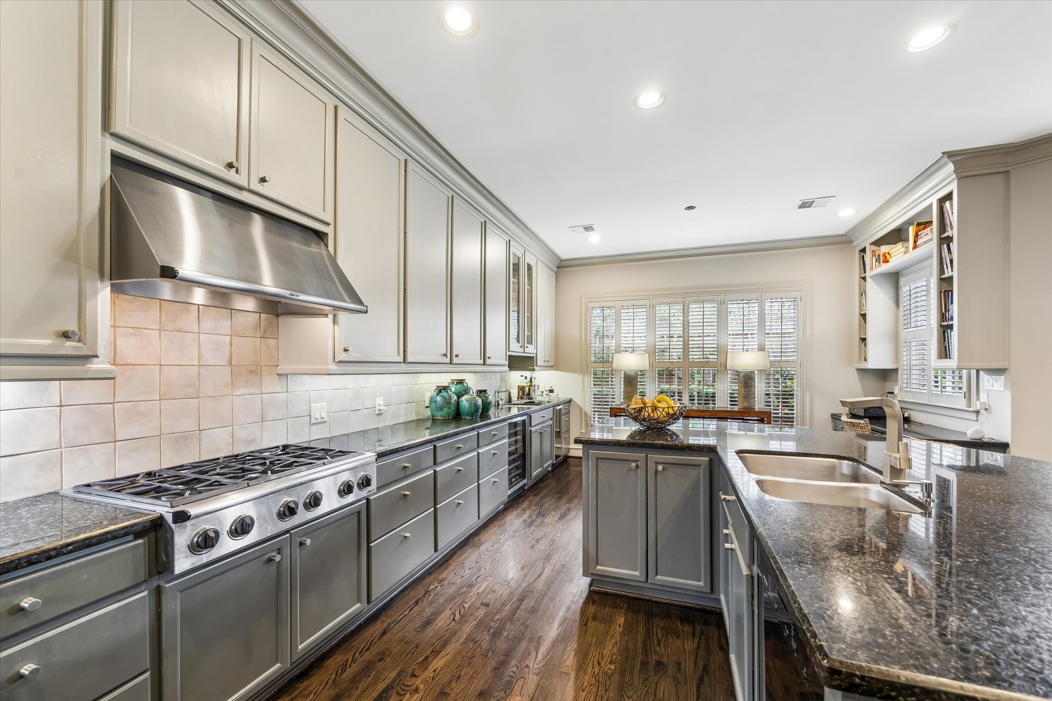 2627 Sutton Court Houston, TX 77027 - Photo 12 of 34 a kitchen with stainless steel appliances granite countertop a stove a sink dishwasher and a microwave oven with wooden cabinets