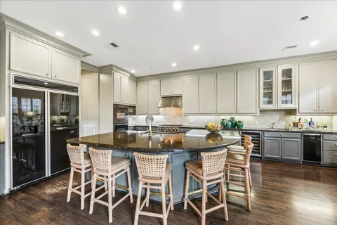 a kitchen with lots of counter top space and view of living room