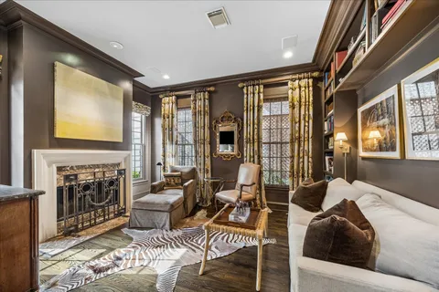 a living room with furniture and floor to ceiling windows