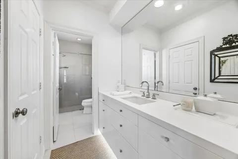 a spacious bedroom with a bed a desk and chair