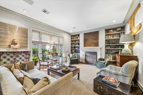 a living room with furniture large window and fireplace