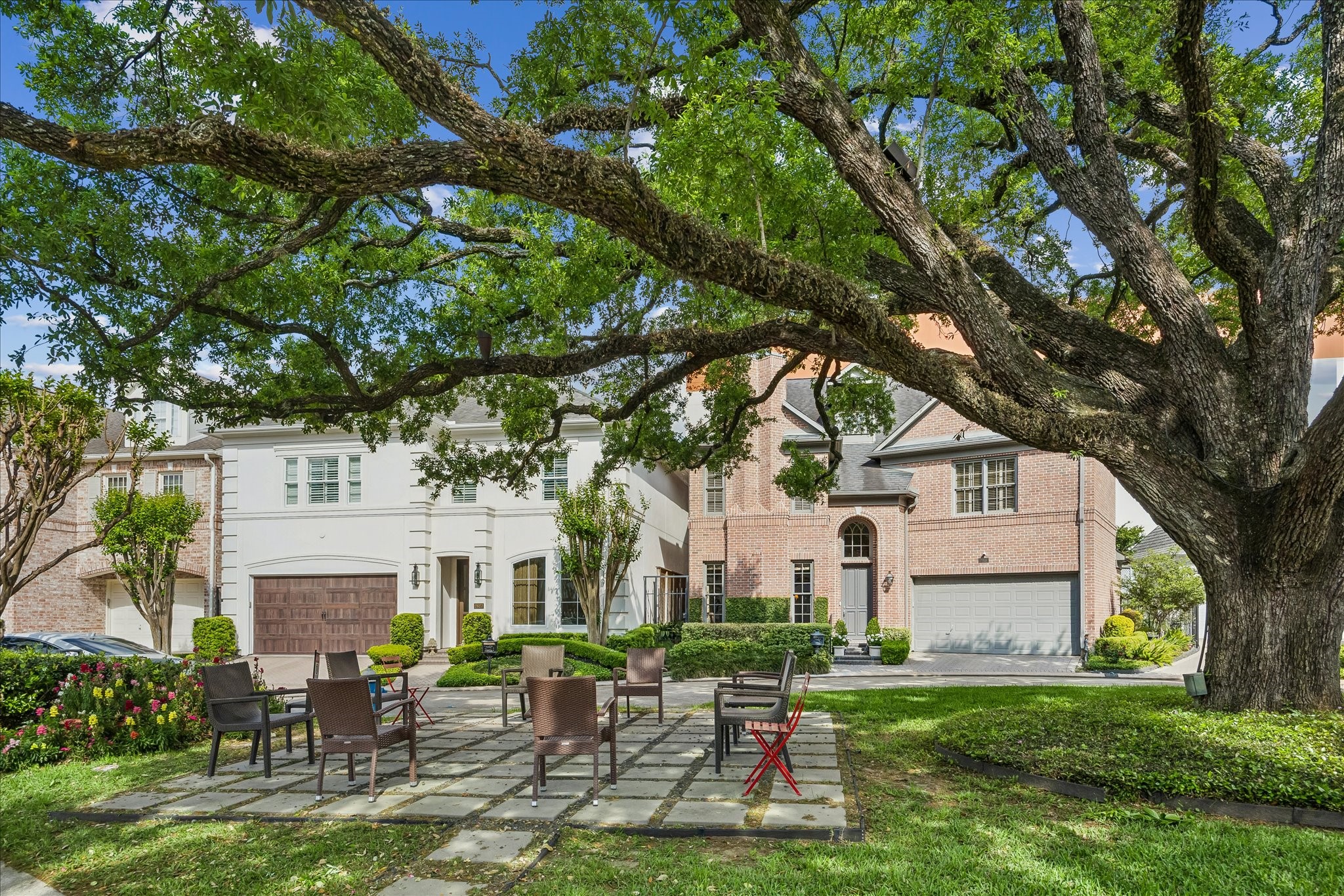 2627 Sutton Court Houston, TX 77027 - Photo 32 of 34 a front view of a house with a yard table and chairs