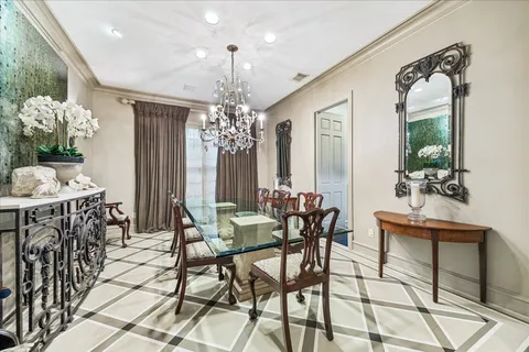a view of a dining room with furniture and chandelier