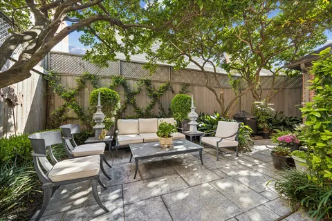 a backyard of a house with outdoor seating
