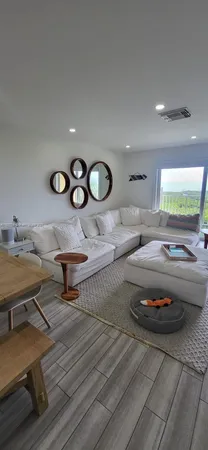 a living room with furniture and a wooden floor