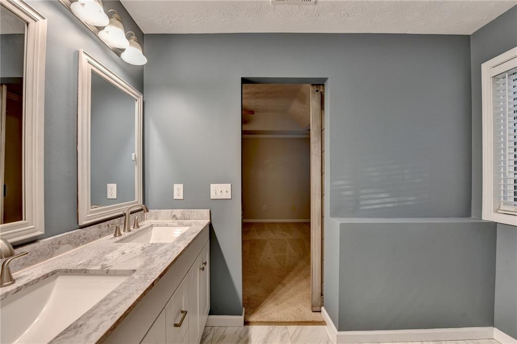 310 Andrew Ridge Drive Jefferson, GA 30549 - Photo 36 of 52 a bathroom with a granite countertop sink and a mirror