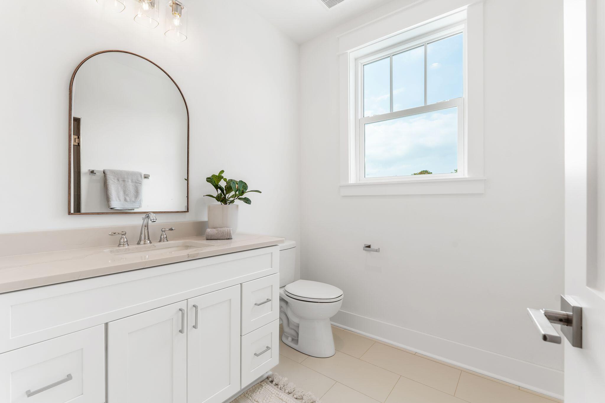 76 Dalton Drive Santa Rosa Beach, FL 32459 - Photo 50 of 71 a bathroom with a granite countertop sink a toilet and a mirror