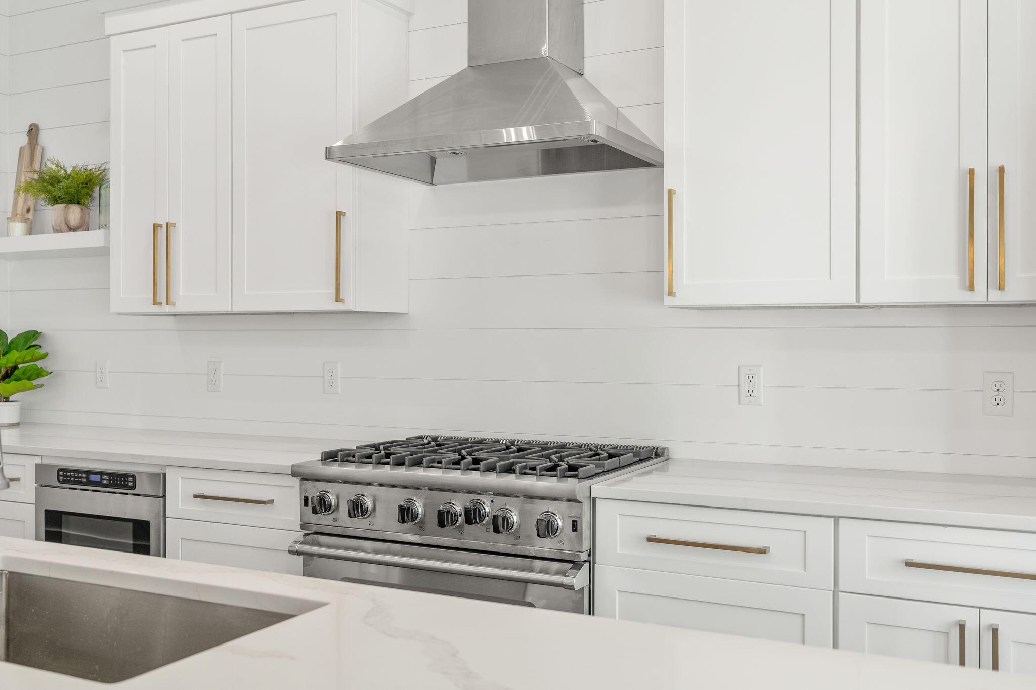 76 Dalton Drive Santa Rosa Beach, FL 32459 - Photo 5 of 71 a kitchen with white cabinets and appliances