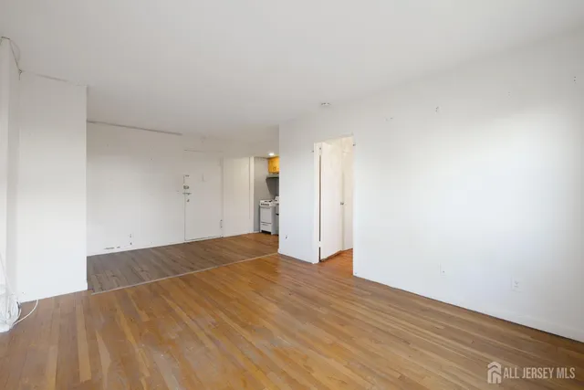 a view of an empty room and wooden floor