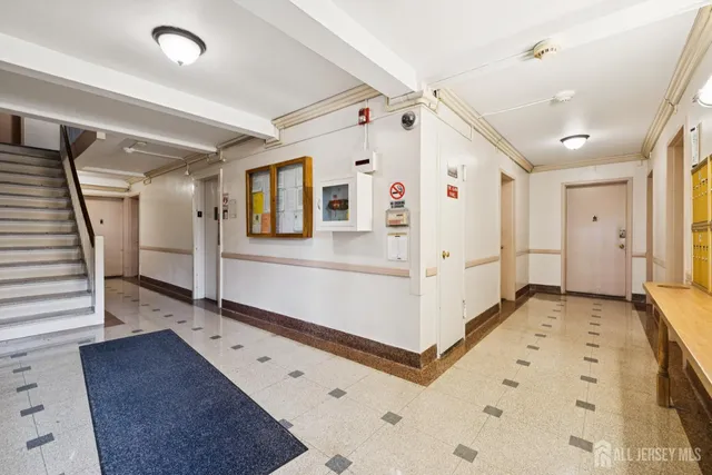 a large white room with wooden floor and white walls