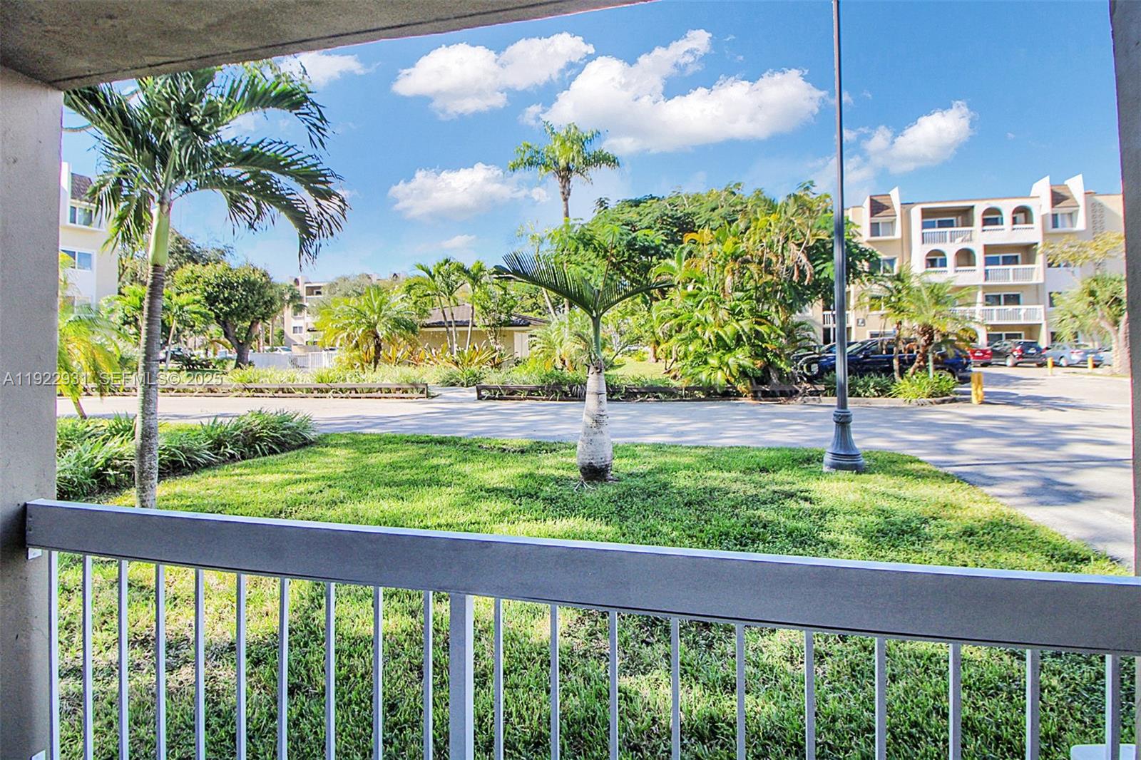 7700 Camino Real, Unit D101 Miami, FL 33143 - Photo 11 of 13 a view of a back yard from a balcony