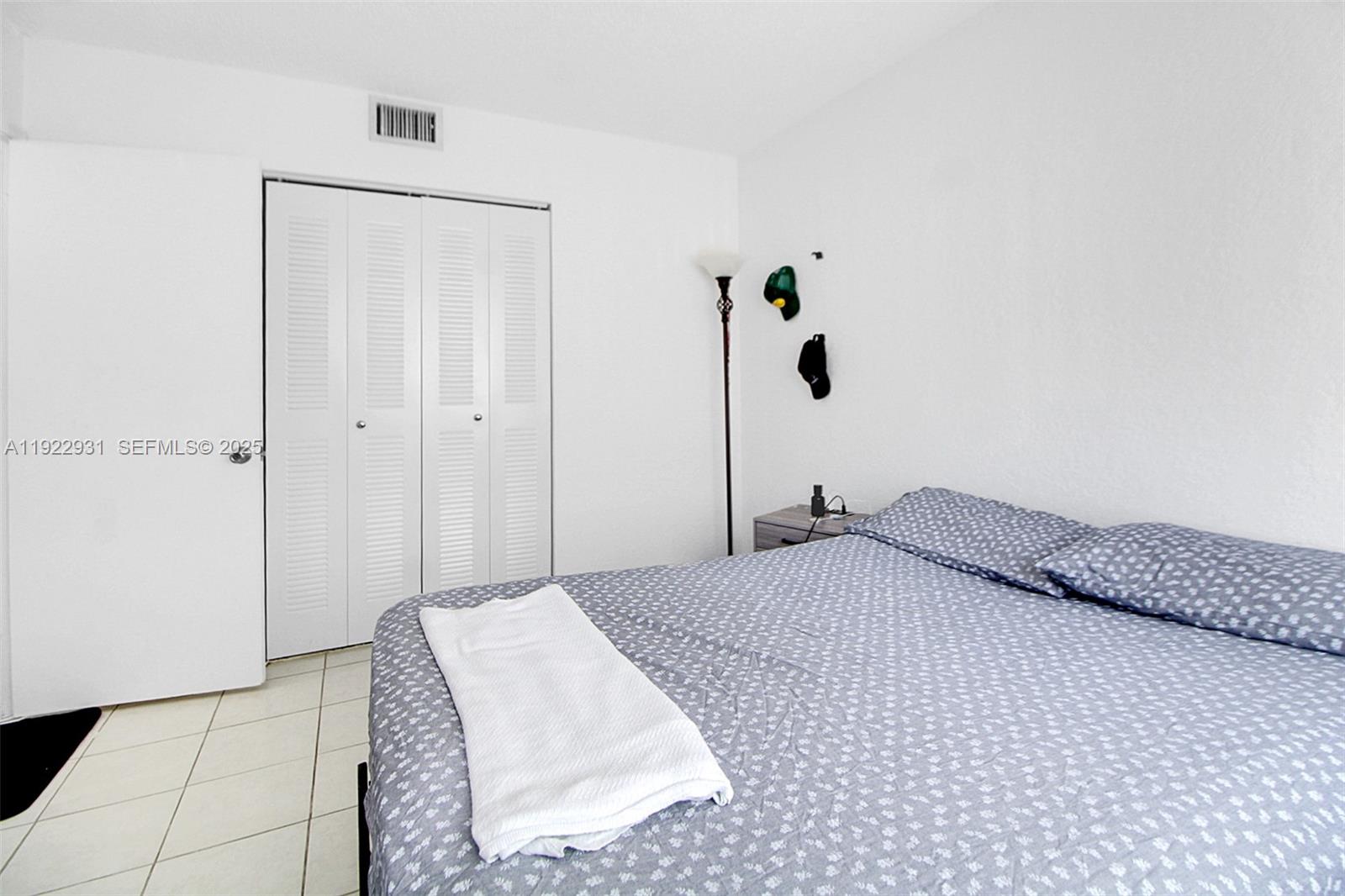7700 Camino Real, Unit D101 Miami, FL 33143 - Photo 8 of 13 a bedroom with a bed and a shower