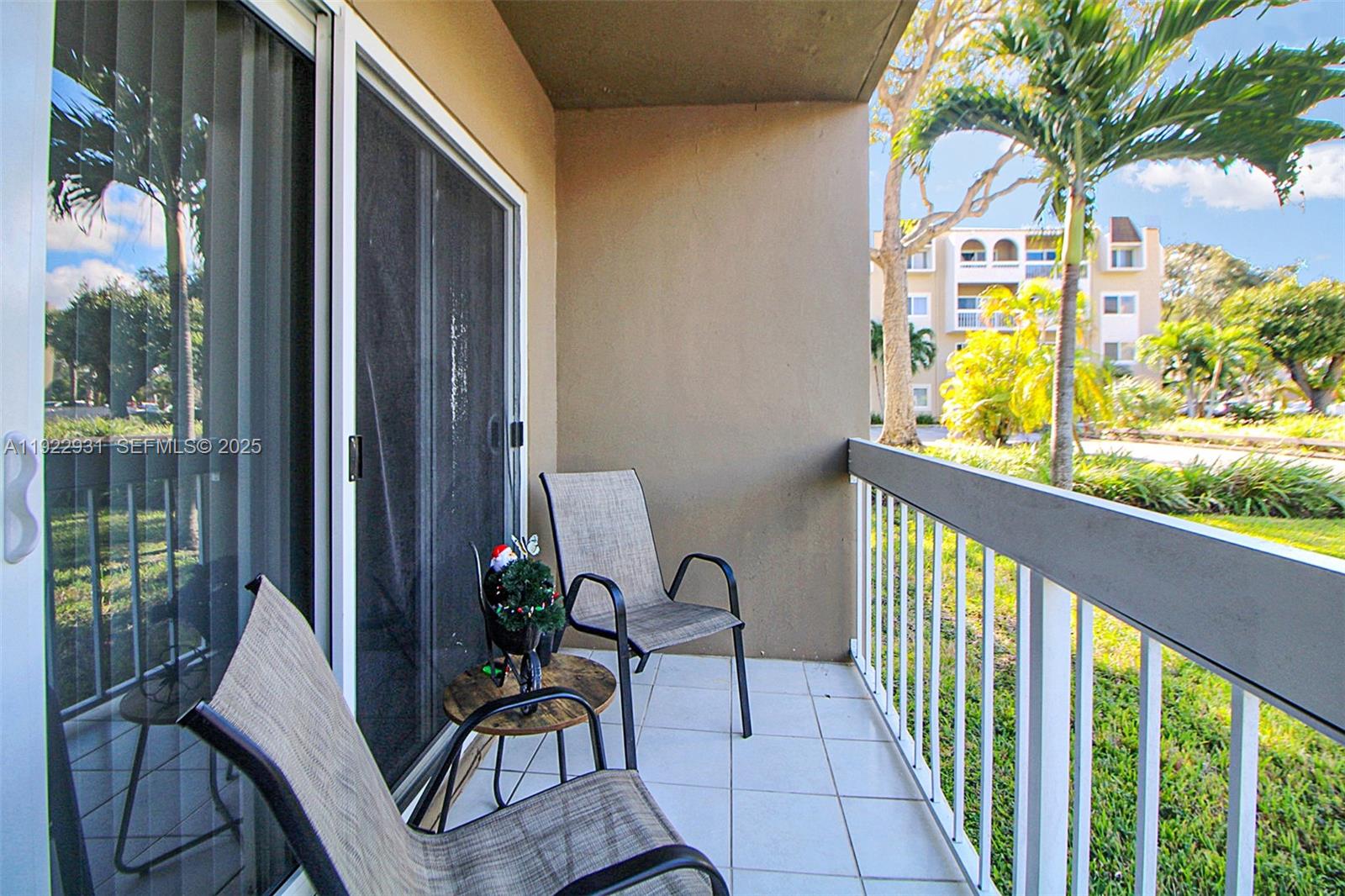 7700 Camino Real, Unit D101 Miami, FL 33143 - Photo 10 of 13 a view of a balcony with chairs