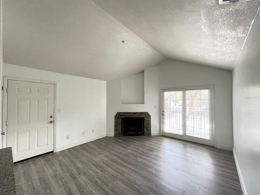 236 Afton Square, Unit 305 Altamonte Springs, FL 32714 - Photo 19 of 30 an empty room with wooden floor cabinet and windows