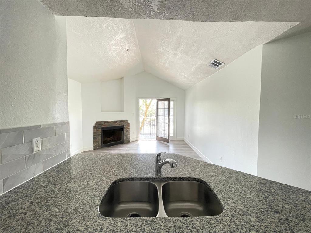 236 Afton Square, Unit 305 Altamonte Springs, FL 32714 - Photo 21 of 30 a kitchen with a sink cabinets and a fireplace