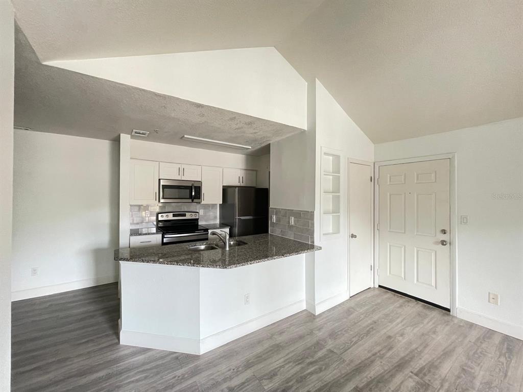 236 Afton Square, Unit 305 Altamonte Springs, FL 32714 - Photo 22 of 30 a view of a living room kitchen and a sink