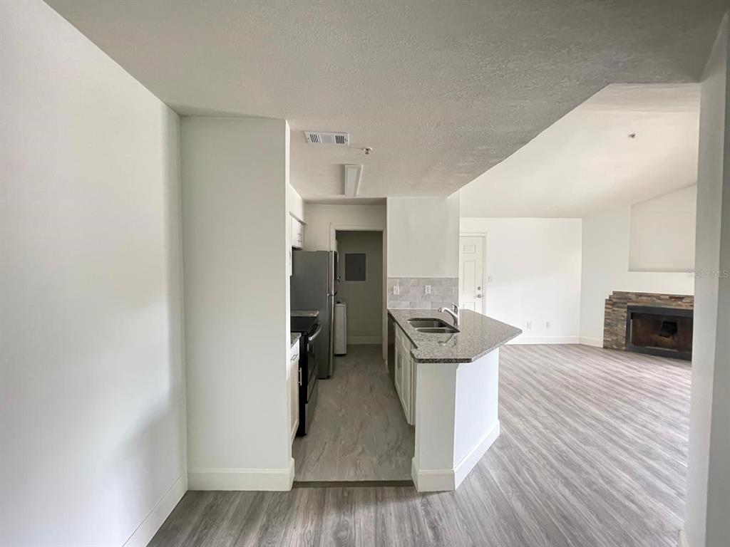 236 Afton Square, Unit 305 Altamonte Springs, FL 32714 - Photo 23 of 30 a view of a kitchen with a sink stove cabinets and empty room