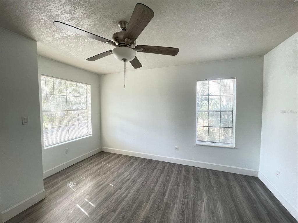 236 Afton Square, Unit 305 Altamonte Springs, FL 32714 - Photo 25 of 30 a view of an empty room with wooden floor and a window