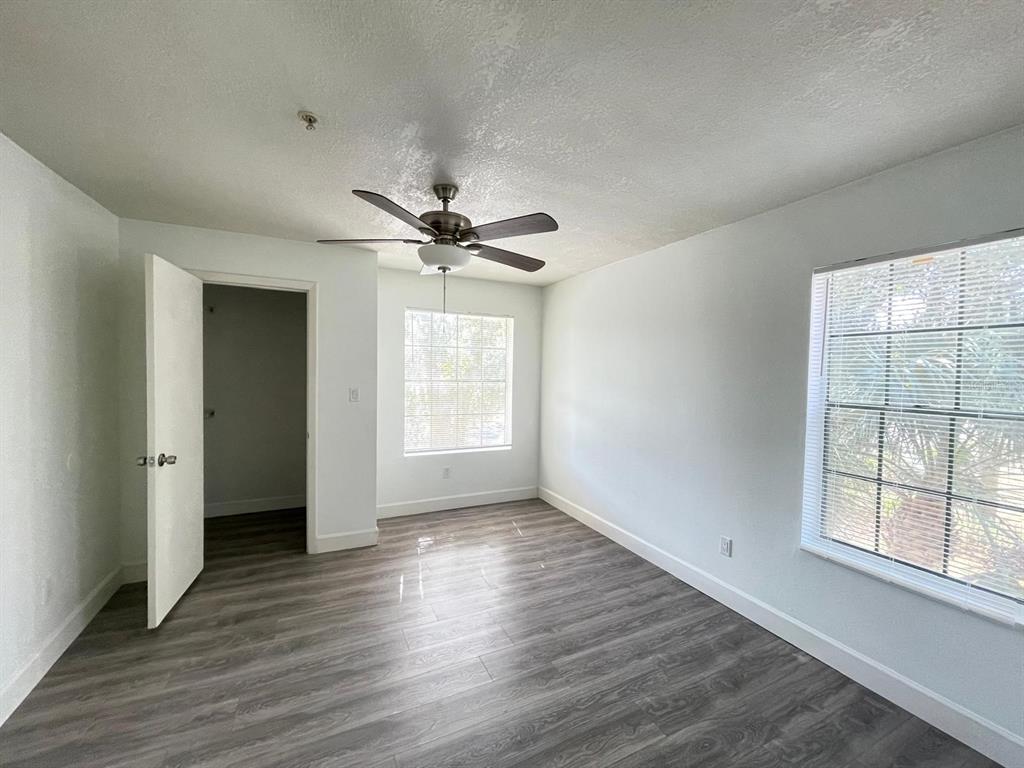 236 Afton Square, Unit 305 Altamonte Springs, FL 32714 - Photo 27 of 30 an empty room with wooden floor fan and windows