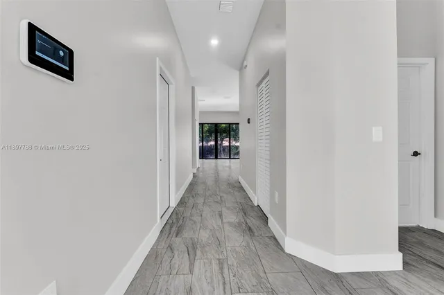 a view of hallway with wooden floor