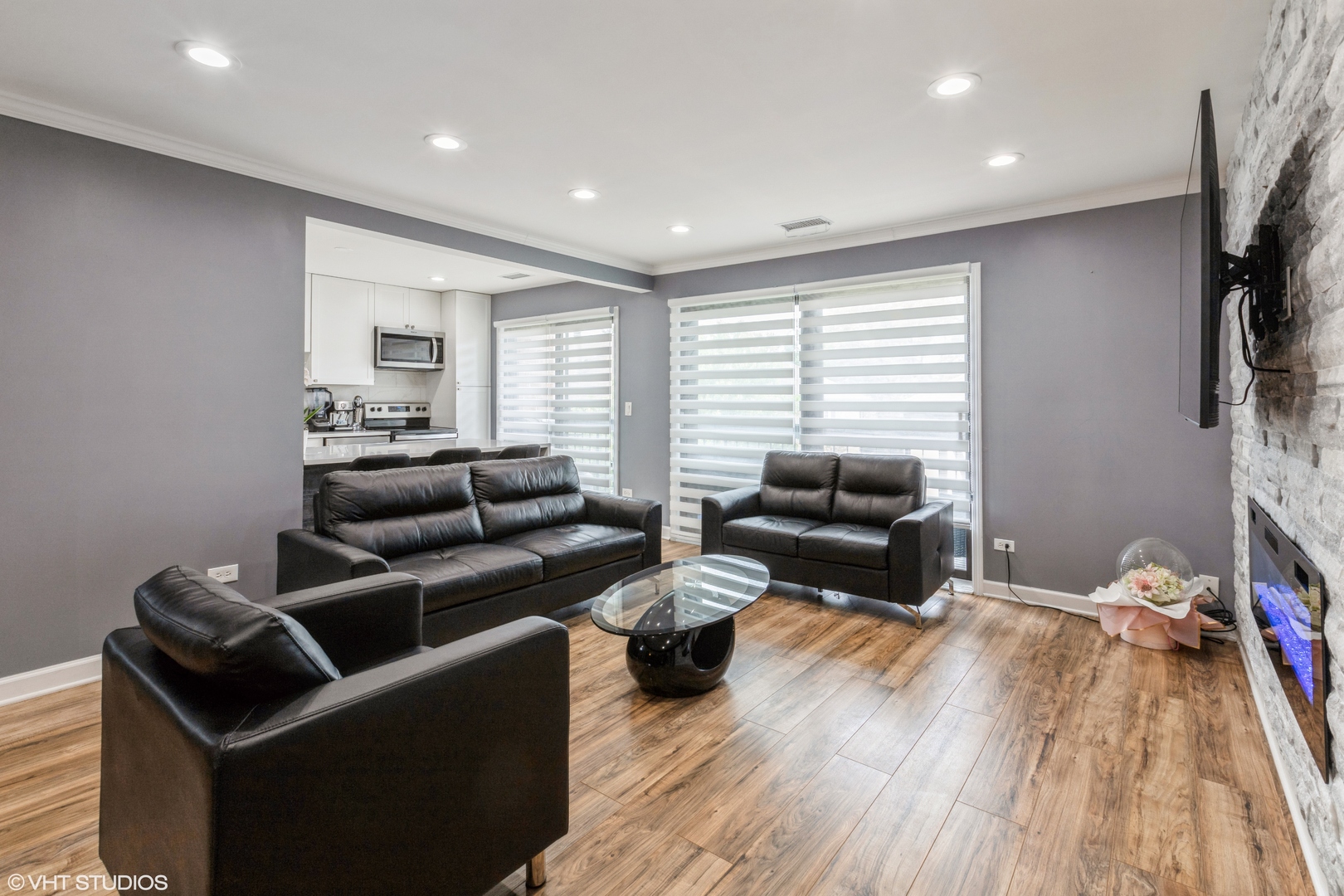232 Stanhope Drive, Unit C Willowbrook, IL 60527 - Photo 11 of 12 a living room with furniture a flat screen tv and a wooden floor