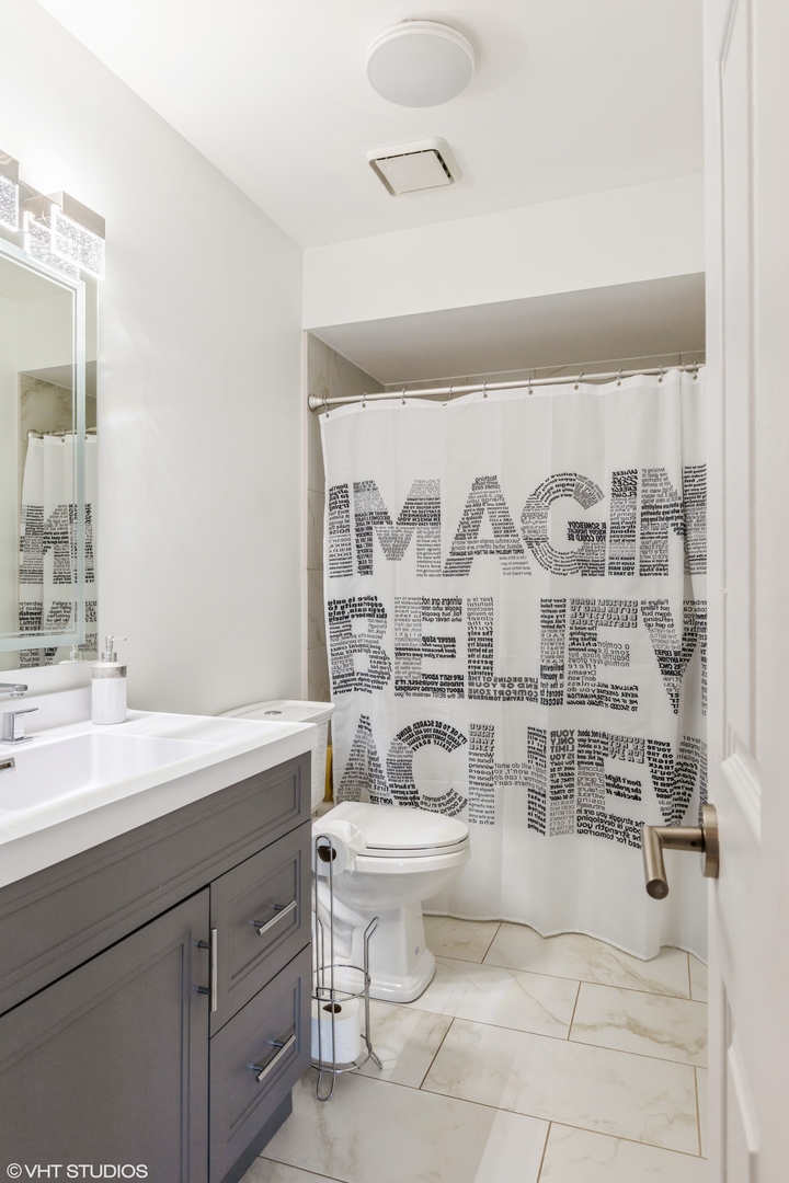 232 Stanhope Drive, Unit C Willowbrook, IL 60527 - Photo 3 of 12 a bathroom with a double vanity sink toilet and shower