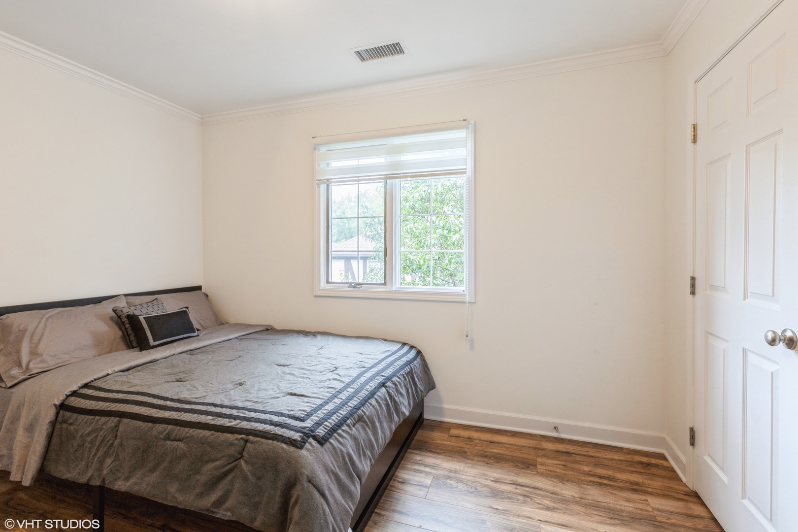 232 Stanhope Drive, Unit C Willowbrook, IL 60527 - Photo 10 of 12 a bedroom with a bed and wooden floor
