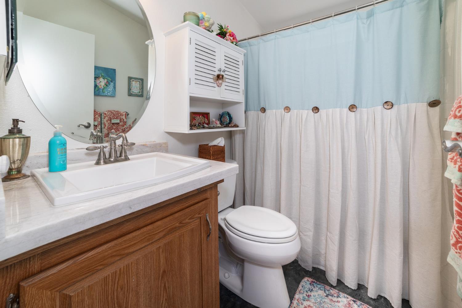 8701 Highway 41, Unit 52 Fresno, CA 93720 - Photo 15 of 66 a bathroom with a sink a toilet and a mirror