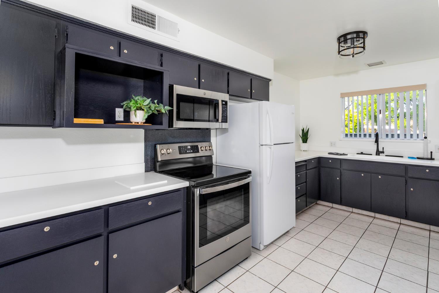 8701 Highway 41, Unit 52 Fresno, CA 93720 - Photo 2 of 66 a kitchen with stainless steel appliances a sink cabinets and a window