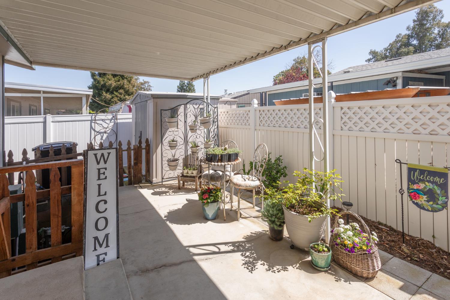 8701 Highway 41, Unit 52 Fresno, CA 93720 - Photo 32 of 66 a view of a patio with table and chairs potted plants