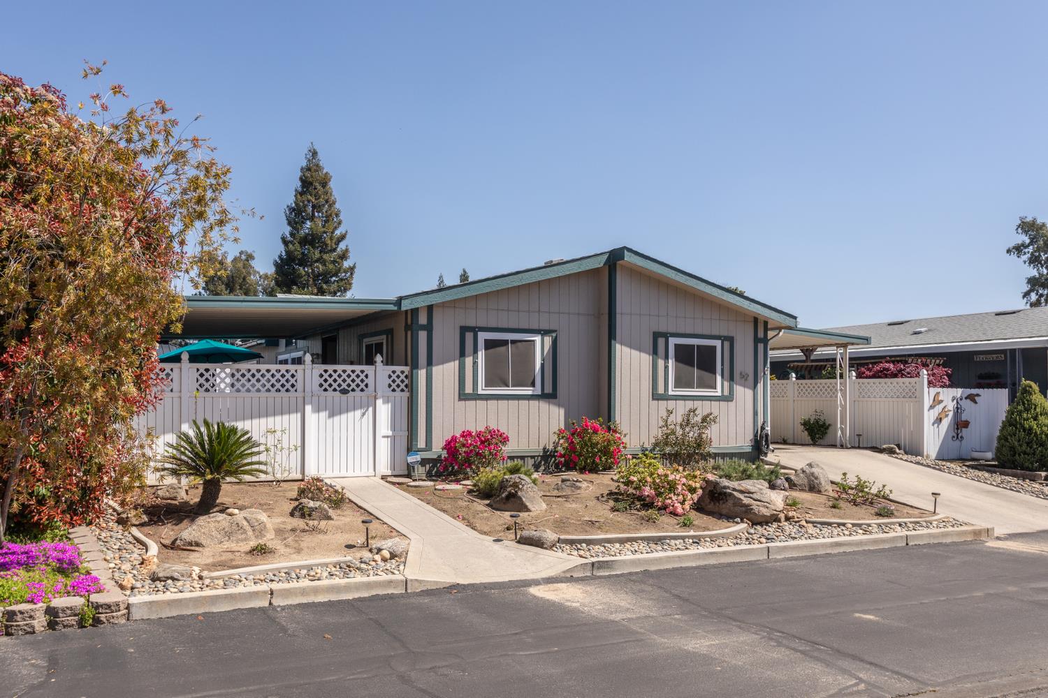 8701 Highway 41, Unit 52 Fresno, CA 93720 - Photo 47 of 66 a front view of a house with a yard and fountain in middle
