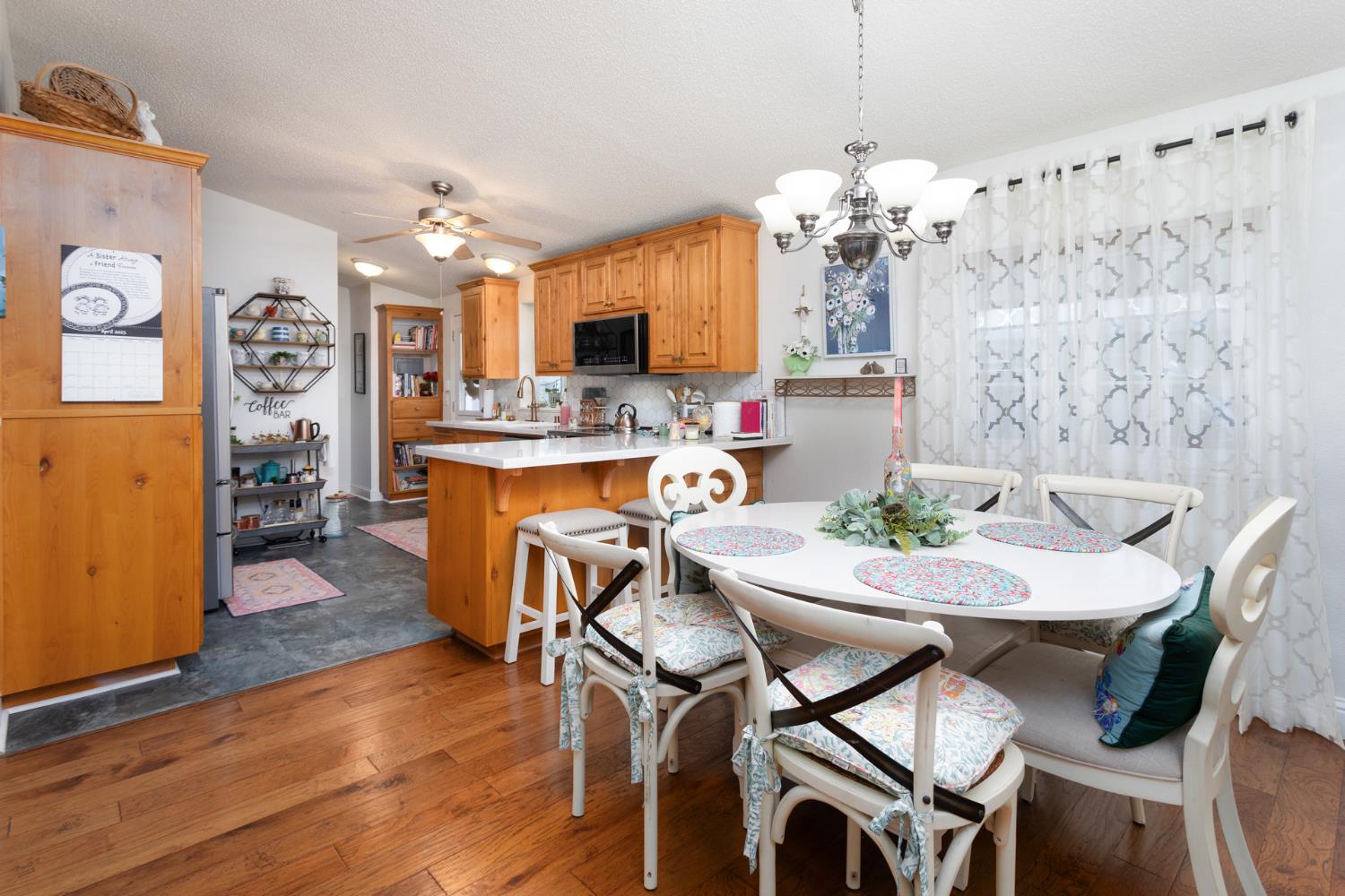8701 Highway 41, Unit 52 Fresno, CA 93720 - Photo 59 of 66 a view of a dining room with furniture window and wooden floor