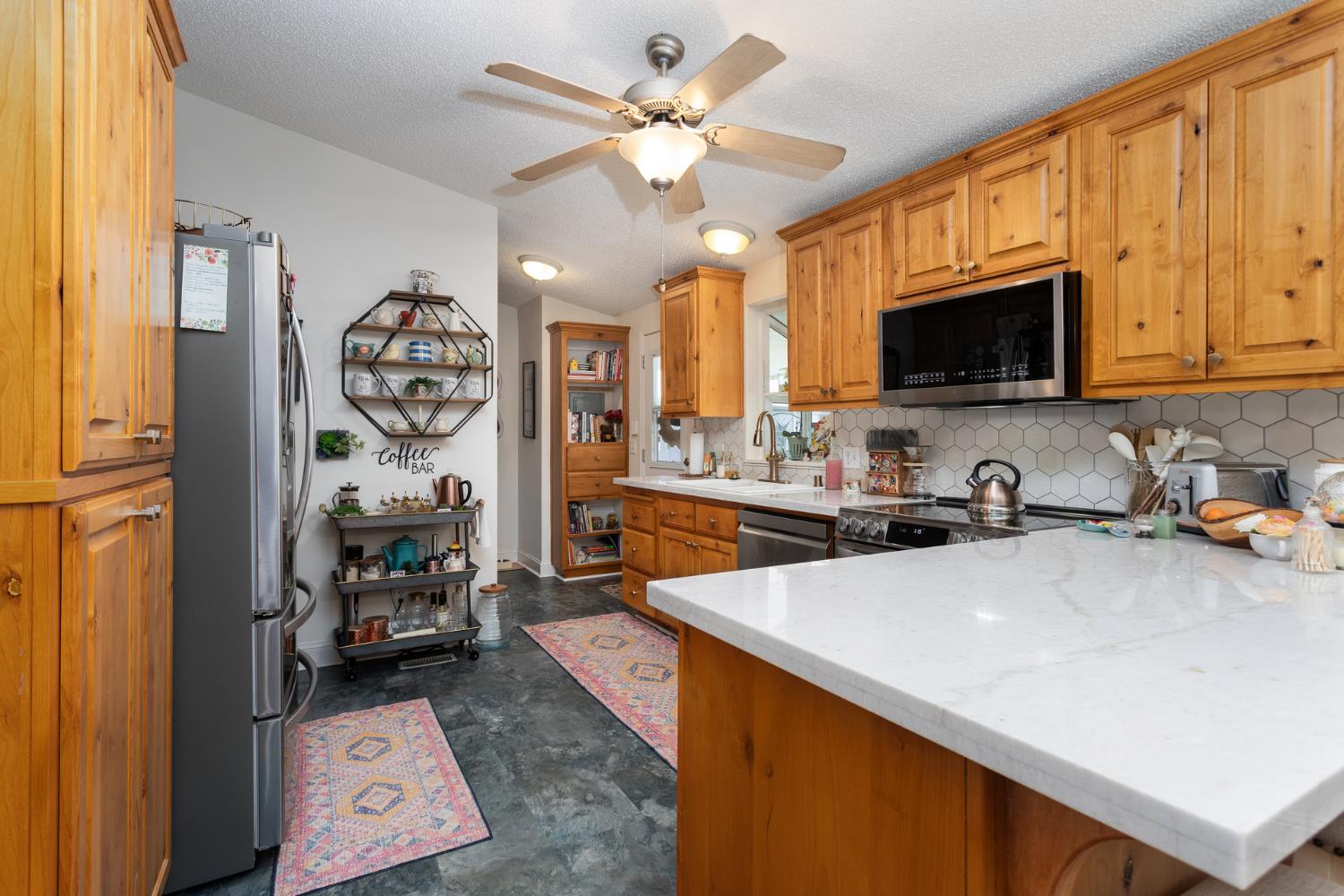 8701 Highway 41, Unit 52 Fresno, CA 93720 - Photo 60 of 66 a kitchen with stainless steel appliances a sink a stove a refrigerator cabinets and a window