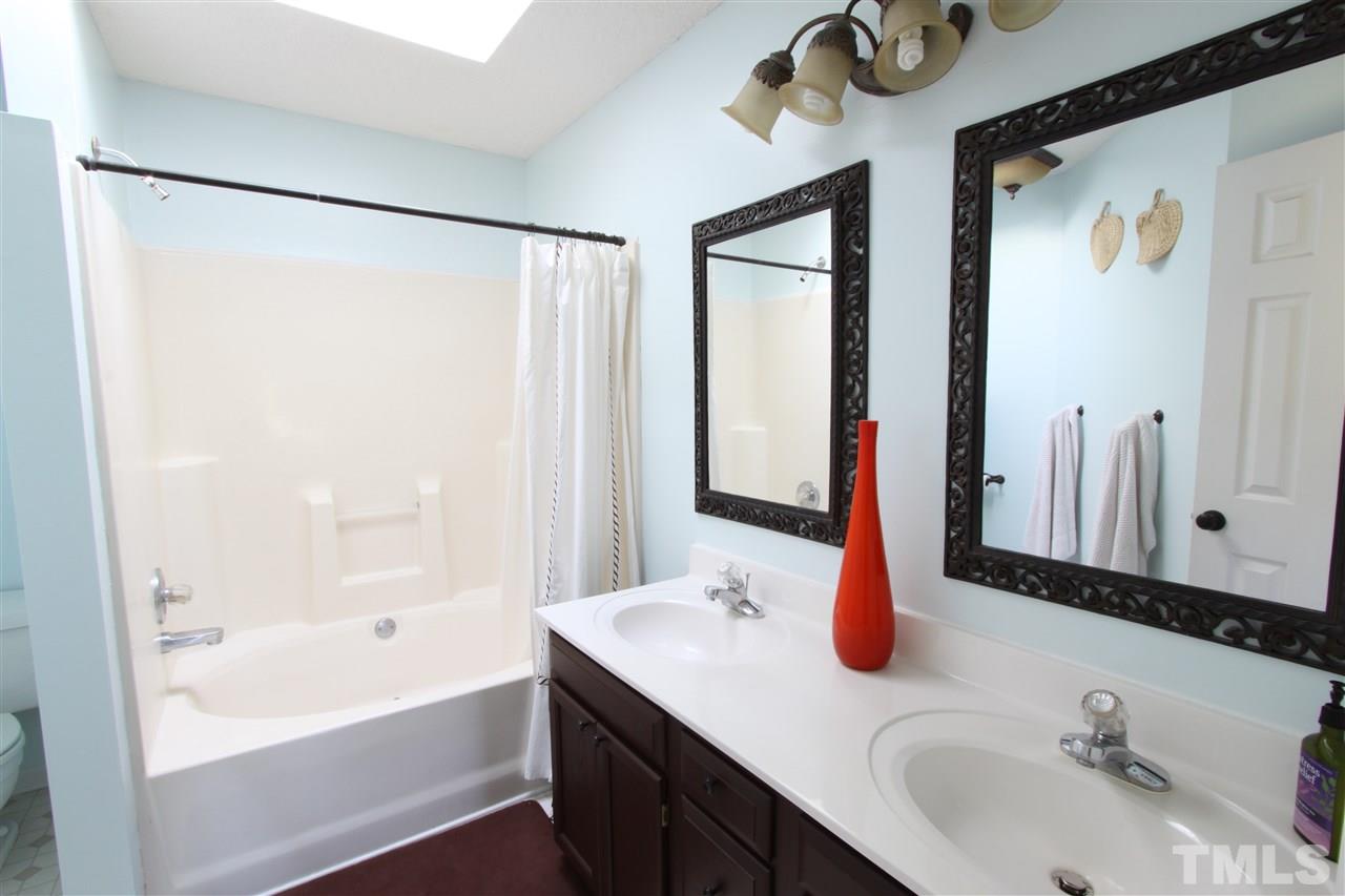 9416 Dawnshire Road Raleigh, NC 27615 - Photo 11 of 17 a bathroom with a sink and a mirror