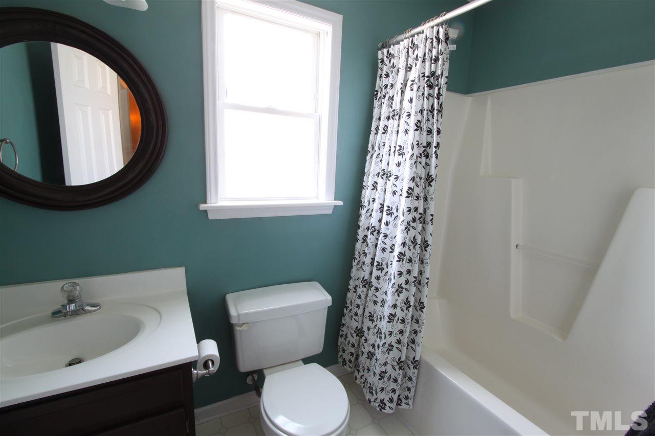 9416 Dawnshire Road Raleigh, NC 27615 - Photo 13 of 17 a bathroom with a bathtub a sink and a toilet