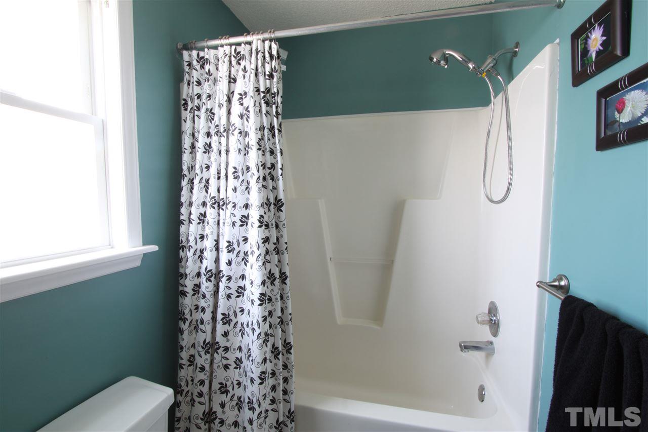 9416 Dawnshire Road Raleigh, NC 27615 - Photo 14 of 17 a bathroom with a shower curtain and a window
