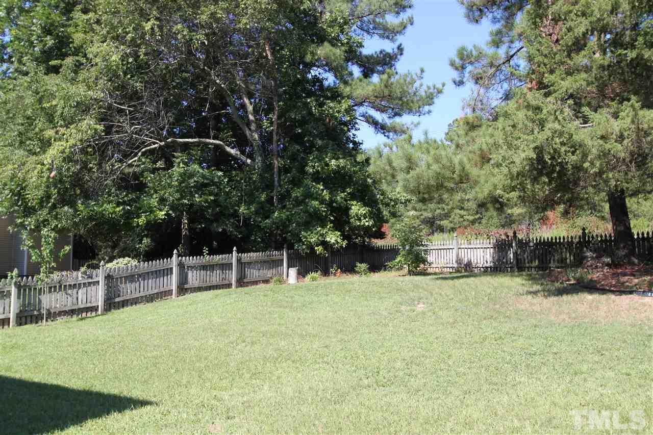 9416 Dawnshire Road Raleigh, NC 27615 - Photo 16 of 17 a view of a chairs and table in the back yard