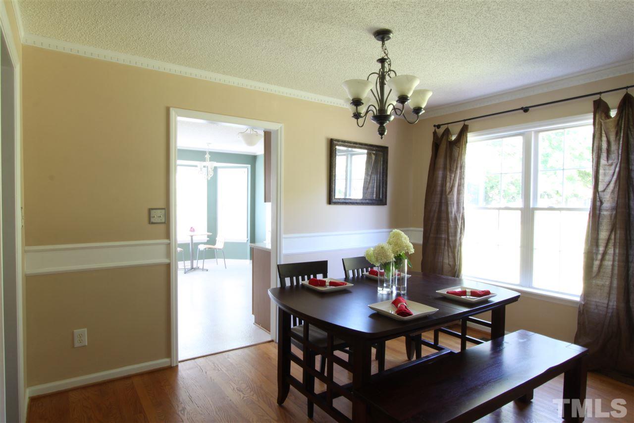 9416 Dawnshire Road Raleigh, NC 27615 - Photo 5 of 17 a view of a dining room with furniture window and wooden floor