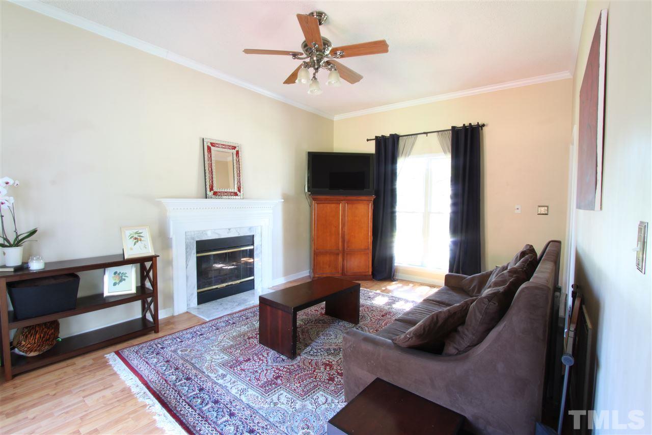9416 Dawnshire Road Raleigh, NC 27615 - Photo 7 of 17 a living room with furniture and a fireplace