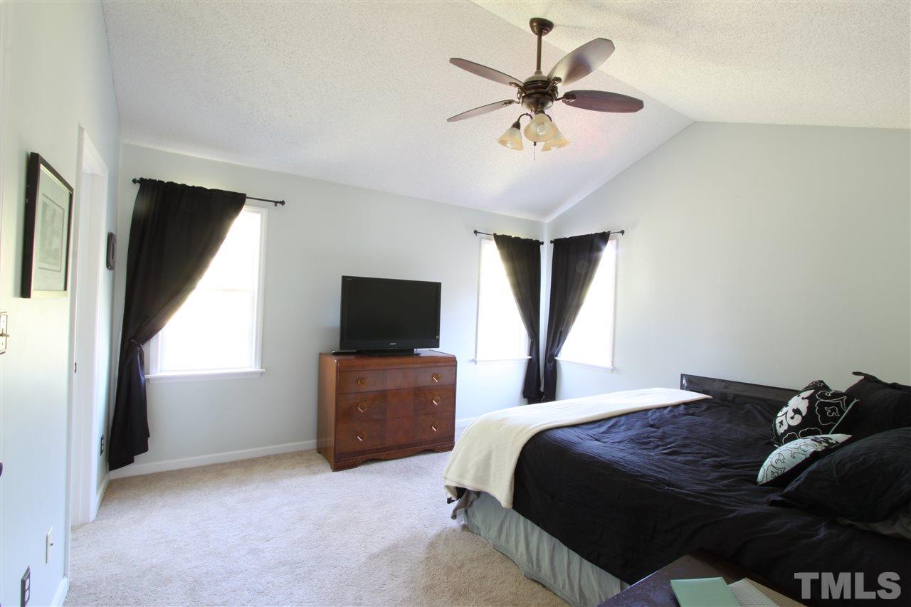 9416 Dawnshire Road Raleigh, NC 27615 - Photo 10 of 17 a bedroom with a bed and a flat screen tv