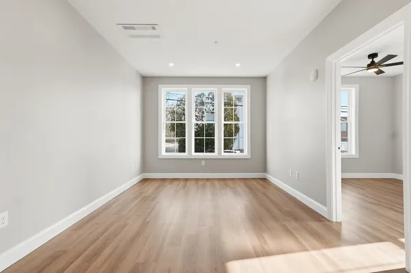 wooden floor in an empty room with a window