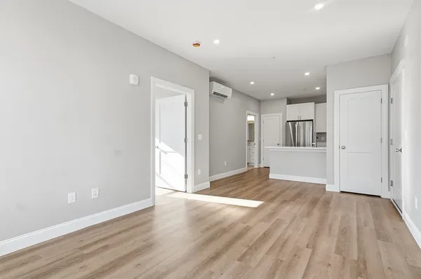 a view of empty room with wooden floor