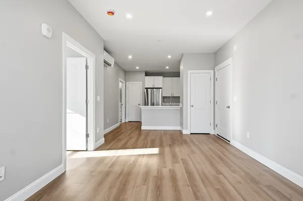 a view of a kitchen with wooden floor